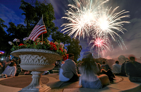 Photo of two attendees watching fireworks at Music in Plymouth