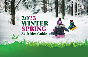 Photo of two children sledding with text that says "2025 Winter Spring Activities Guide." At the bottom of the photo is green grass.