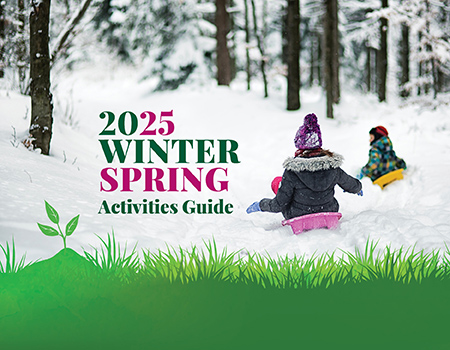 Photo of two children sledding with text that says "2025 Winter Spring Activities Guide." At the bottom of the photo is green grass.